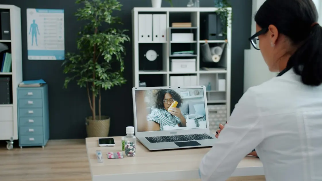 Video consultation — a doctor talking with a patient over a laptop