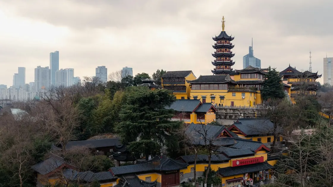 Jiming Temple's yellow buildings and pagoda against Nanjing's skyline